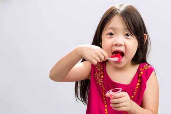 child eating jelly